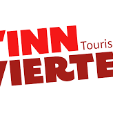This appears to be a partial view of a red text logo or sign. The word "VIERTE" is clearly visible along with what seems to be "INN" preceding it, suggesting it may be related to tourism based on the visible text fragment "Touris" at the bottom.